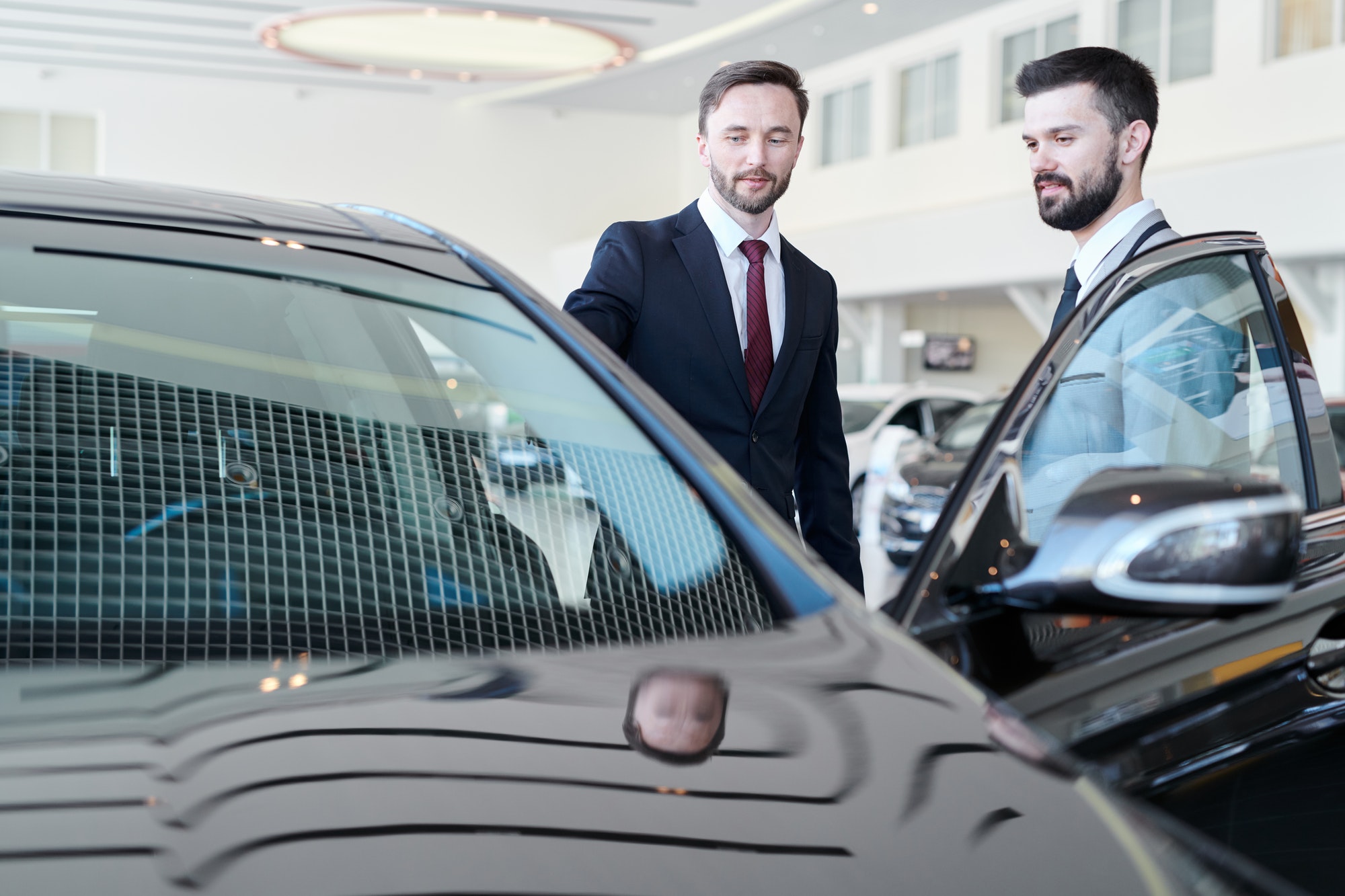 man-choosing-a-car-with-car-dealer.jpg